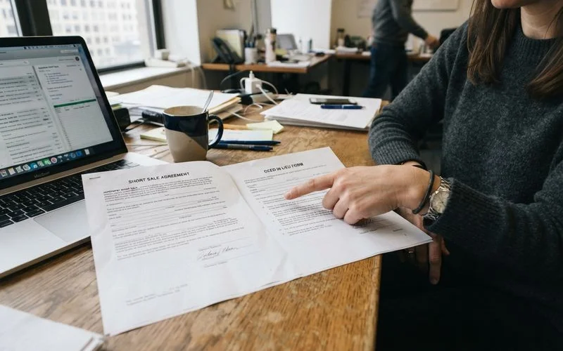 A homeowner and real estate attorney comparing short sale and deed-in-lieu paperwork